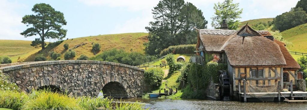 A future house-sit with a thatched roof, dock and bridge.